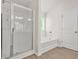 Bright bathroom featuring a glass shower and a soaking tub at 603 River Gardens Se Dr, Atlanta, GA 30354