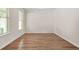 Dining room with wood-look flooring, neutral paint, white trim, and window views at 603 River Gardens Se Dr, Atlanta, GA 30354