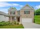 Charming two-story brick home with a well-manicured lawn, attached garage, and inviting covered front porch at 603 River Gardens Se Dr, Atlanta, GA 30354