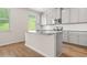 Bright kitchen featuring stainless steel appliances, gray cabinetry, subway tile backsplash, and granite counters at 603 River Gardens Se Dr, Atlanta, GA 30354