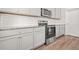 Modern kitchen with stainless steel appliances and gray cabinetry at 603 River Gardens Se Dr, Atlanta, GA 30354