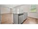 Open-concept kitchen island with stainless steel dishwasher and eat-in breakfast bar at 603 River Gardens Se Dr, Atlanta, GA 30354