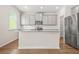 Modern kitchen with gray cabinets, stainless appliances, granite countertops, and wood-look flooring at 603 River Gardens Se Dr, Atlanta, GA 30354