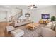 Cozy living room with wood-look flooring, a staircase, and comfortable seating at 603 River Gardens Se Dr, Atlanta, GA 30354