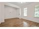 Living room with wood-look flooring, neutral paint, white trim, chandelier, and sunlit windows at 603 River Gardens Se Dr, Atlanta, GA 30354