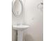 Bathroom with pedestal sink, mirror, and vanity lighting at 603 River Gardens Se Dr, Atlanta, GA 30354