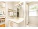 Bathroom featuring a white vanity with gold fixtures and a view of a bedroom and adjacent shower at 824 Greenwood Ne Ave # 9, Atlanta, GA 30306