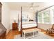 Charming bedroom featuring a four-poster bed, hardwood floors, and natural light from the windows at 824 Greenwood Ne Ave # 9, Atlanta, GA 30306