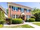 Charming two-story brick home featuring a red tile roof, manicured bushes, and a well-maintained lawn at 824 Greenwood Ne Ave # 9, Atlanta, GA 30306