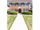 Exterior view of a two-story brick home featuring a red tile roof and manicured bushes at 824 Greenwood Ne Ave # 9, Atlanta, GA 30306