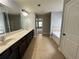 Bathroom featuring double vanity, a tub and neutral tile flooring at 3522 Fallen Oak Dr, Buford, GA 30519