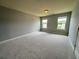 Bedroom featuring neutral walls, carpet, and two windows at 3522 Fallen Oak Dr, Buford, GA 30519