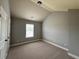 Neutral bedroom featuring sloped ceilings and natural light at 3522 Fallen Oak Dr, Buford, GA 30519