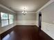 Elegant dining room boasts hardwood floors, wainscoting, and a stylish chandelier at 3522 Fallen Oak Dr, Buford, GA 30519