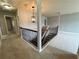 Upstairs hallway with wrought iron banister and neutral carpeting at 3522 Fallen Oak Dr, Buford, GA 30519