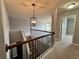 View of the upstairs hall featuring stairs, modern lighting, and neutral colors at 3522 Fallen Oak Dr, Buford, GA 30519