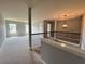 Upstairs hallway with wrought iron banister and neutral carpeting at 3522 Fallen Oak Dr, Buford, GA 30519