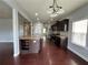 Large kitchen and living space featuring hardwood floors, granite counters and stainless appliances at 3522 Fallen Oak Dr, Buford, GA 30519