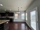 Open-concept kitchen features stainless appliances and dark cabinetry at 3522 Fallen Oak Dr, Buford, GA 30519