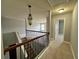 Upstairs landing with staircase, and neutral carpeting at 3522 Fallen Oak Dr, Buford, GA 30519