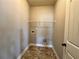 Laundry room featuring tile floor, shelving, and washer/dryer hookups at 3522 Fallen Oak Dr, Buford, GA 30519
