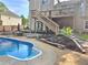 Backyard pool and deck view with wood staircase leading to the second level at 4284 Caroline Ct, Douglasville, GA 30135