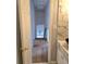 Bathroom hallway featuring marble tiled wall and chandelier lighting at 4284 Caroline Ct, Douglasville, GA 30135