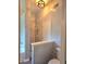 Modern bathroom featuring marble-patterned tile, glass shower, and a separate toilet area, creating a spa-like atmosphere at 4284 Caroline Ct, Douglasville, GA 30135