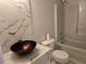 Modern bathroom featuring a marble vanity with a unique sink, toilet and tub with shower at 4284 Caroline Ct, Douglasville, GA 30135