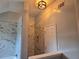 Modern bathroom featuring marble-patterned tile, glass shower, and a separate toilet area, creating a spa-like atmosphere at 4284 Caroline Ct, Douglasville, GA 30135