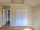 Bedroom featuring hardwood floors, neutral walls, closet, and doors to other spaces at 4284 Caroline Ct, Douglasville, GA 30135