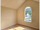 Bedroom with a large window allowing natural light and hardwood flooring and neutral paint at 4284 Caroline Ct, Douglasville, GA 30135