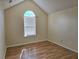 Cozy bedroom featuring wood floors, neutral color palette, and a large window with privacy blinds at 4284 Caroline Ct, Douglasville, GA 30135