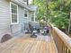 Back deck featuring wood plank flooring and outdoor furniture and natural landscaping at 4284 Caroline Ct, Douglasville, GA 30135