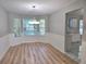 Dining area featuring wood floors, wainscotting, and a chandelier adjacent to the kitchen at 4284 Caroline Ct, Douglasville, GA 30135