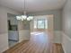 View of dining area showing wood floors, wainscotting, and access to both the kitchen and living room at 4284 Caroline Ct, Douglasville, GA 30135