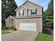 Side view of a charming two-story home with a two-car garage and manicured front lawn at 4284 Caroline Ct, Douglasville, GA 30135