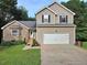 Inviting two-story home with a two-car garage, stone accents, and well-maintained lawn at 4284 Caroline Ct, Douglasville, GA 30135