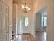Inviting foyer with elegant chandelier, beautiful front door, and gleaming hardwood floors at 4284 Caroline Ct, Douglasville, GA 30135