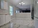Eat-in kitchen with marble-look tile floors offering an open concept to the adjacent living room at 4284 Caroline Ct, Douglasville, GA 30135