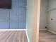A laundry room with wood floors and wall shelves near the living room at 4284 Caroline Ct, Douglasville, GA 30135