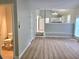 Open-concept living room featuring modern flooring and neutral paint tones, with a glimpse into the adjacent kitchen at 4284 Caroline Ct, Douglasville, GA 30135