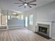 Living room with wood floors, fireplace, and view to kitchen with stainless appliances at 4284 Caroline Ct, Douglasville, GA 30135