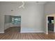 Open-concept living room with modern light fixture, hardwood floors, and views into other rooms at 4284 Caroline Ct, Douglasville, GA 30135