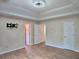 Main bedroom with trey ceiling, hardwood floors, with a TV mount, doors leading to other spaces at 4284 Caroline Ct, Douglasville, GA 30135