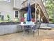 Outdoor patio featuring a table and chairs with lush greenery and landscaping at 4284 Caroline Ct, Douglasville, GA 30135
