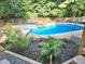 In-ground pool and hot tub surrounded by lush landscaping at 4284 Caroline Ct, Douglasville, GA 30135