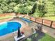 Backyard pool and patio with an enclosed fence and mature landscaping at 4284 Caroline Ct, Douglasville, GA 30135