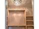 Inside walk-in closet with custom wood shelving, hanging rods and a decorative chandelier, offering style and functionality at 4284 Caroline Ct, Douglasville, GA 30135