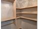 Walk-in closet with custom wood shelving and hanging rods providing ample storage solutions, maximizing organization at 4284 Caroline Ct, Douglasville, GA 30135